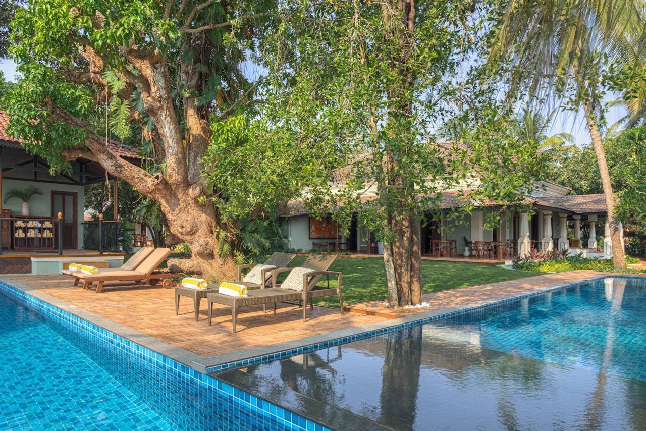 Mastering the First Impression: Your intriguing post title goes here Elegant villa with pool surrounded by lush greenery in Arpora, Goa, India.